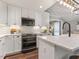 Bright kitchen with white cabinets, stainless steel appliances, and white tile backsplash at 3900 Maplefield Dr, Raleigh, NC 27613