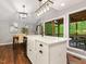 Open kitchen with a white farmhouse sink island, stainless appliances, and an adjacent dining area at 3900 Maplefield Dr, Raleigh, NC 27613