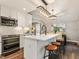 Bright open kitchen with white cabinets, an island with stool seating and stainless steel appliances at 3900 Maplefield Dr, Raleigh, NC 27613