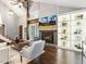Open living room with vaulted ceilings, fireplace, shelving, and staircase to the second floor at 3900 Maplefield Dr, Raleigh, NC 27613