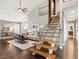 Sunlit living room with wood floors, cathedral ceilings and staircase at 3900 Maplefield Dr, Raleigh, NC 27613