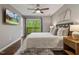 Main bedroom with a ceiling fan, hardwood floors, and a sliding glass door at 3900 Maplefield Dr, Raleigh, NC 27613