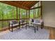 A screened porch features outdoor furniture and provides a relaxing view of the surrounding trees at 3900 Maplefield Dr, Raleigh, NC 27613