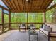 Relaxing screened porch features stylish furniture and peaceful views of the surrounding trees at 3900 Maplefield Dr, Raleigh, NC 27613