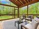 Relaxing screened porch featuring comfortable seating and a view of the lush, wooded backyard at 3900 Maplefield Dr, Raleigh, NC 27613