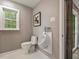 Modern powder room with a sleek toilet, urinal, and a minimalist design aesthetic for a sophisticated touch at 3900 Maplefield Dr, Raleigh, NC 27613