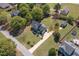 Aerial view of the home showcasing its manicured lawn, long driveway, and landscaping at 3905 Autumn Creek Dr, Fuquay Varina, NC 27526