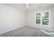 A bright and airy bedroom with a large window offers natural light at 3905 Autumn Creek Dr, Fuquay Varina, NC 27526
