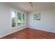 Sunlit bedroom featuring hardwood floors, three-casement windows and neutral paint at 3905 Autumn Creek Dr, Fuquay Varina, NC 27526