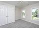 Bedroom with double windows and a closet, complete with cozy gray carpet at 3905 Autumn Creek Dr, Fuquay Varina, NC 27526