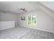 A large bonus room with a window and cozy carpet at 3905 Autumn Creek Dr, Fuquay Varina, NC 27526