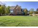 Inviting two-story brick and siding home with green lawn and well-manicured landscaping at 3905 Autumn Creek Dr, Fuquay Varina, NC 27526