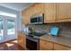 Kitchen showcases stainless appliances, wood cabinets, and cooktop at 3905 Autumn Creek Dr, Fuquay Varina, NC 27526