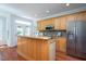 Well-appointed kitchen featuring wood cabinetry, stainless steel appliances, and tile backsplash at 3905 Autumn Creek Dr, Fuquay Varina, NC 27526