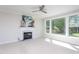 Comfortable living room with fireplace, large windows, ceiling fan, and neutral carpet at 3905 Autumn Creek Dr, Fuquay Varina, NC 27526