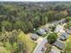 A high angle captures a residential neighborhood with well-maintained homes surrounded by mature trees, fostering a secluded feel at 420 Feldspar Way, Durham, NC 27703