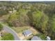 An aerial view of a charming single-Gathering home with a fenced backyard surrounded by lush greenery and trees at 420 Feldspar Way, Durham, NC 27703