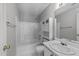 Bathroom with shower-tub combo, white vanity, and storage cabinet at 420 Feldspar Way, Durham, NC 27703