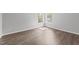 Empty bedroom with new flooring and natural light from the double windows at 420 Feldspar Way, Durham, NC 27703