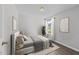 Cozy bedroom features neutral decor, a window, and accent art at 420 Feldspar Way, Durham, NC 27703