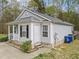 Home exterior featuring a gray siding, well-maintained landscaping, and an inviting entrance at 420 Feldspar Way, Durham, NC 27703