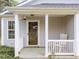Charming front porch with white railing and rocking chair, perfect for relaxing outdoors at 420 Feldspar Way, Durham, NC 27703