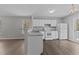Efficient kitchen with white cabinets, modern appliances, and breakfast bar at 420 Feldspar Way, Durham, NC 27703
