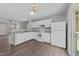 Kitchen featuring white cabinets, stainless steel appliances, and an eat-in bar at 420 Feldspar Way, Durham, NC 27703