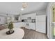 Modern kitchen with white cabinetry and stainless steel appliances with outdoor access at 420 Feldspar Way, Durham, NC 27703