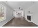 Spacious living room with hardwood floors, a fireplace, and a ceiling fan at 420 Feldspar Way, Durham, NC 27703