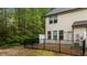 This backyard features an enclosed patio area surrounded by lush greenery, creating a tranquil outdoor retreat at 4523 Tarkiln Pl, Wake Forest, NC 27587