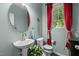 Stylish powder room featuring a pedestal sink and decorative accents at 4523 Tarkiln Pl, Wake Forest, NC 27587
