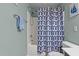This is a clean bathroom featuring a combination shower and tub with coordinated blue patterned shower curtain at 4523 Tarkiln Pl, Wake Forest, NC 27587
