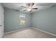 This is a serene bedroom features a ceiling fan and a window with a view of the neighborhood at 4523 Tarkiln Pl, Wake Forest, NC 27587