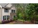 Charming two-story townhome featuring stone accents and a well-manicured front yard at 4523 Tarkiln Pl, Wake Forest, NC 27587