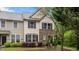 Charming townhome featuring a stone facade and well-maintained landscaping at 4523 Tarkiln Pl, Wake Forest, NC 27587