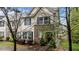 Attractive two-story townhome with stone facade, neat landscaping, and inviting entryway at 4523 Tarkiln Pl, Wake Forest, NC 27587
