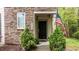 Inviting front entry of home showcasing stone details and decorative landscaping at 4523 Tarkiln Pl, Wake Forest, NC 27587