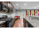 A kitchen view showing granite countertops, a breakfast nook, dark wood cabinets and stainless appliances at 4523 Tarkiln Pl, Wake Forest, NC 27587