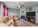 Cozy living room with a plush sectional couch, fireplace, and a patterned rug at 4523 Tarkiln Pl, Wake Forest, NC 27587