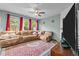 A spacious living room featuring a large sectional couch, fireplace, and large windows at 4523 Tarkiln Pl, Wake Forest, NC 27587
