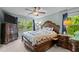 A main bedroom showcasing a large bed, side tables, dressers and lots of natural light at 4523 Tarkiln Pl, Wake Forest, NC 27587