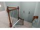 A staircase featuring carpeted steps, wooden handrails, and black metal spindles at 4523 Tarkiln Pl, Wake Forest, NC 27587