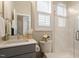 Bathroom features a tiled shower, gray vanity, and natural light at 463 Old Piedmont Cir, Chapel Hill, NC 27516