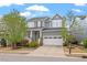 Beautifully landscaped two-story home with a covered porch, a two-car garage and mature trees at 463 Old Piedmont Cir, Chapel Hill, NC 27516