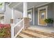 Inviting front porch with stone accents, detailed railings, and a bright, welcoming entrance at 463 Old Piedmont Cir, Chapel Hill, NC 27516