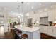 Bright, open kitchen featuring a large island with seating, stainless steel appliances, and pendant lighting at 463 Old Piedmont Cir, Chapel Hill, NC 27516
