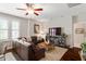 This warm living room features a ceiling fan, a leather couch, and plenty of natural light at 463 Old Piedmont Cir, Chapel Hill, NC 27516