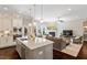 Open-concept kitchen flows into a cozy living room with a fireplace and backyard access at 463 Old Piedmont Cir, Chapel Hill, NC 27516