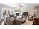 Comfortable living room features large windows, a fireplace, and a neutral color palette at 463 Old Piedmont Cir, Chapel Hill, NC 27516